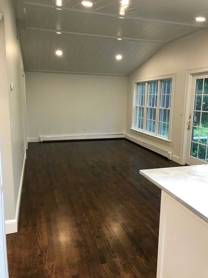 Freshly cleaned great room after post-construction cleaning — polished hardwood, dust-free windows and trim
