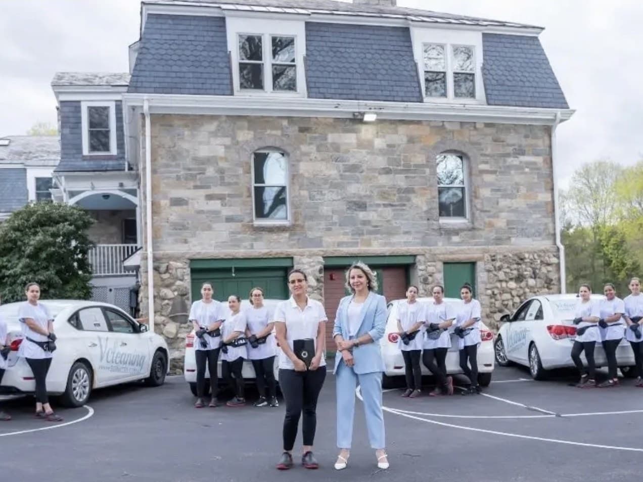 The Vcleaning Services team standing with the company vehicles in Clinton, Massachusetts