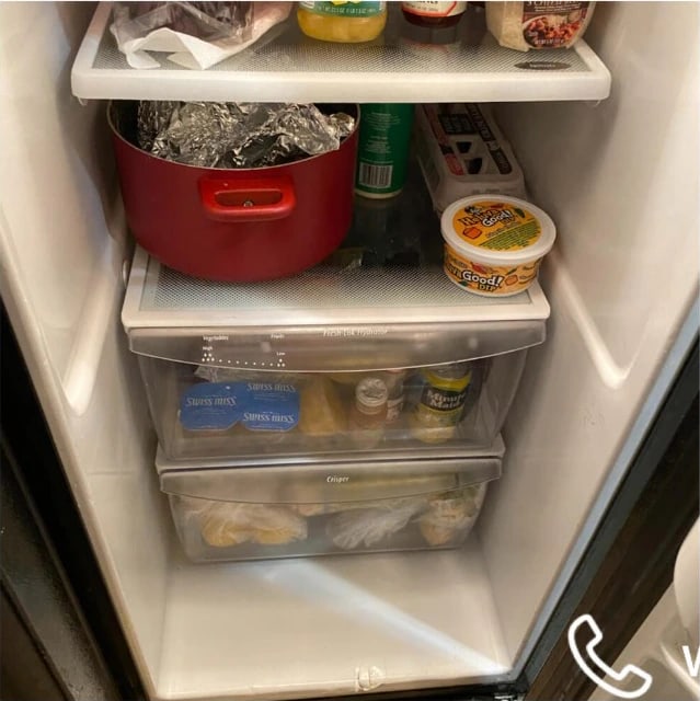 The same refrigerator after cleaning — shelves and drawers wiped and the cabinet floor clear
