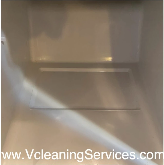 The same refrigerator shelf after cleaning — white surface clean to the seams