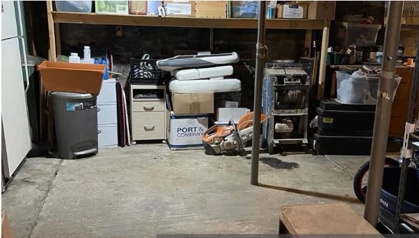 The same corner after cleaning — floor clear and swept, remaining items stored on shelving